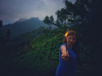 Full length of woman standing on mountain against sky