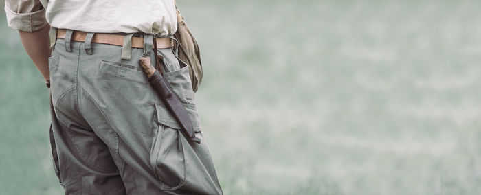 Midsection of scout standing on field