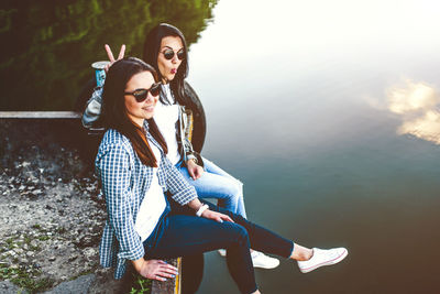 Young couple sitting by lake