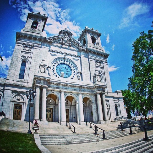 building exterior, architecture, built structure, sky, church, low angle view, place of worship, religion, facade, spirituality, blue, cloud, history, sunlight, cloud - sky, travel destinations, day