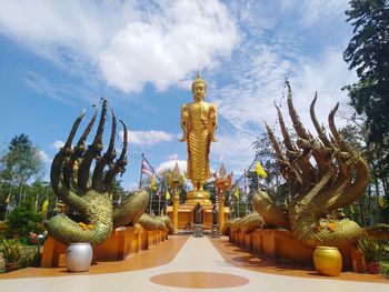 Statue at temple against sky