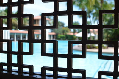 Swimming pool seen through metal grate