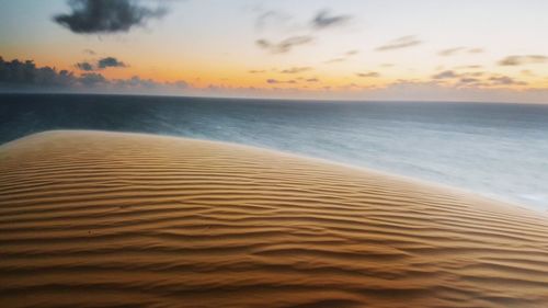 Scenic view of beach at sunset