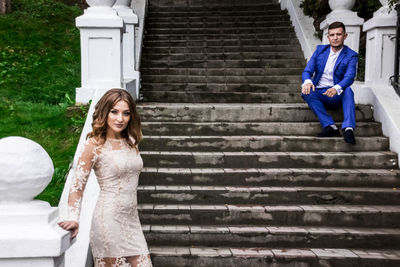 Happy woman sitting on staircase