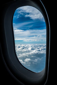 Scenic view of cloudscape seen through airplane window