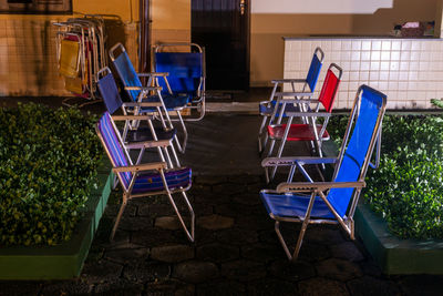 Empty chairs and tables at sidewalk cafe