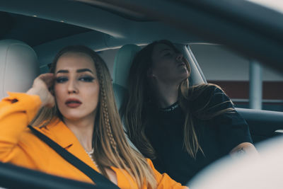 Young woman sitting in car