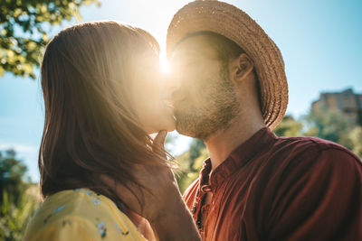 Close-up of romantic couple during sunny day