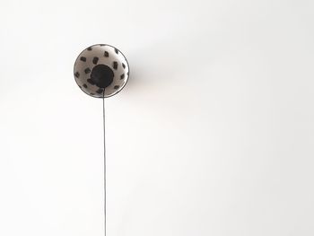 Low angle view of electric lamp against white background