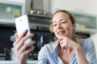 Portrait of young woman using mobile phone