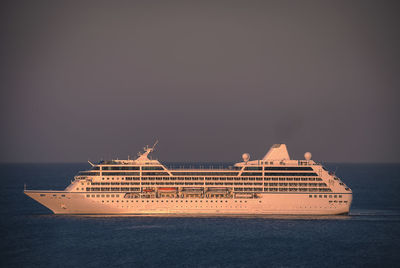 Ship sailing in sea against clear sky