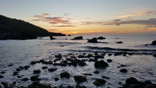 Scenic view of sea against sky at sunset