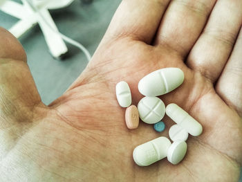 Close-up of hand holding pills 