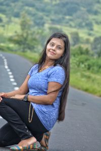 Portrait of beautiful young woman on road