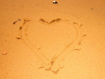 Close-up of footprints on sand at beach