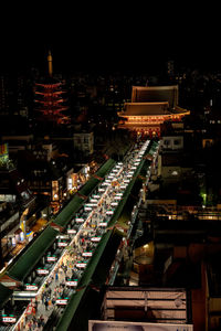 High angle view of illuminated buildings in city at night