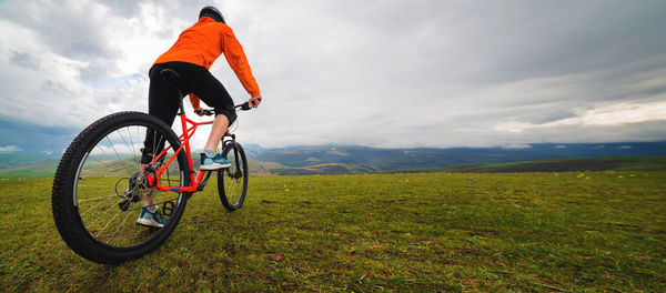 Cycling. a man on an enduro bike stands in a landscape in the mountains. outdoor sports