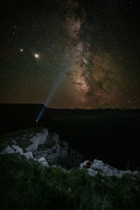 Scenic view of rocks against sky at night