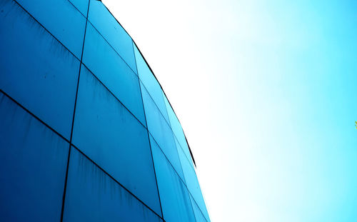 Low angle view of modern building against clear blue sky