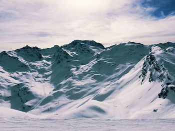 Scenic view of snowcapped mountains against sky