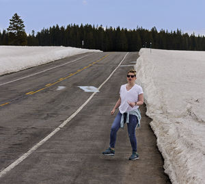 Full length portrait of young man standing against sky