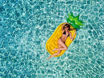 Directly above shot of woman relaxing on pool raft