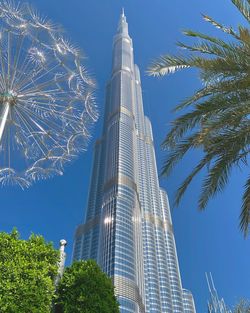 Low angle view of modern building against blue sky