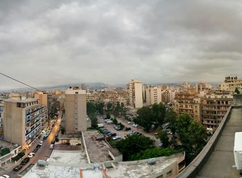 City buildings against cloudy sky