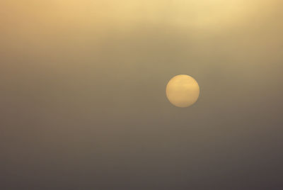 Low angle view of moon against sky at sunset