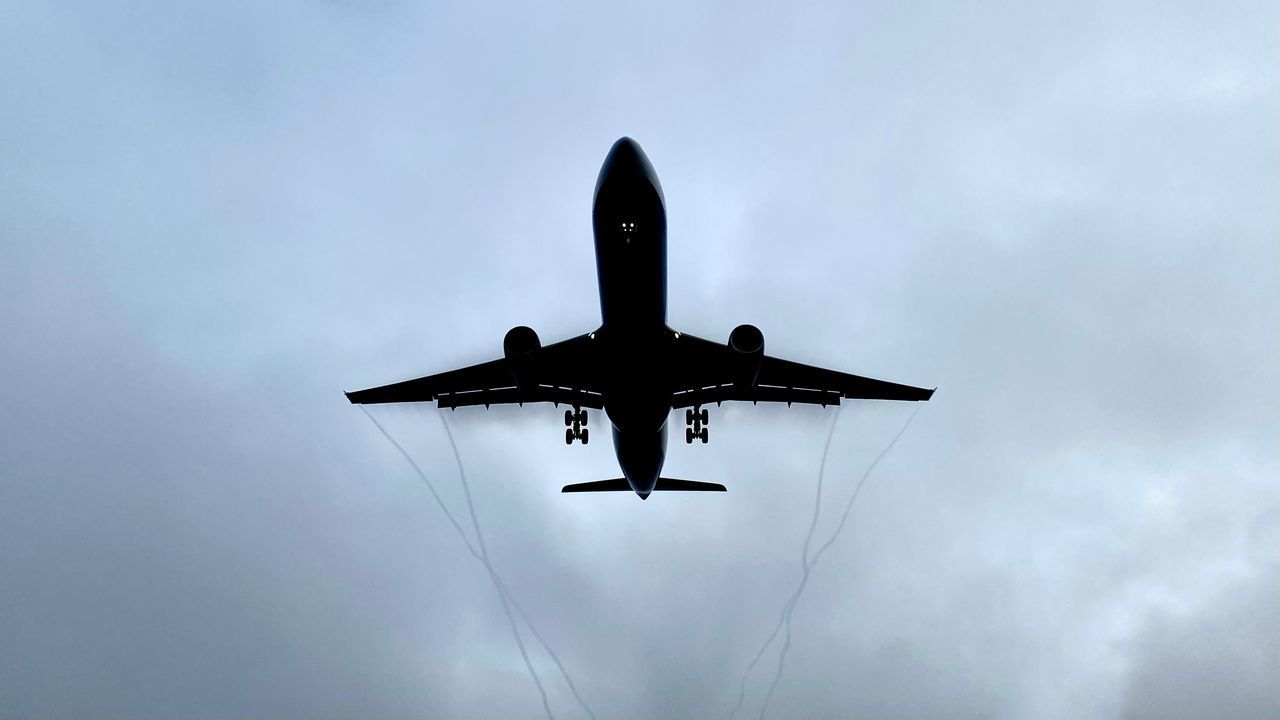 LOW ANGLE VIEW OF AIRPLANE IN SKY