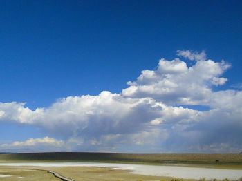 Scenic view of landscape against blue sky