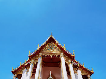 Low angle view of traditional building against clear blue sky