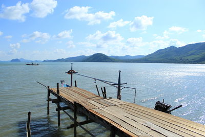 Pier over lake against sky