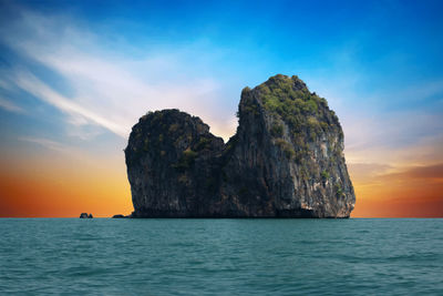 Scenic view of rock formation in sea against sky