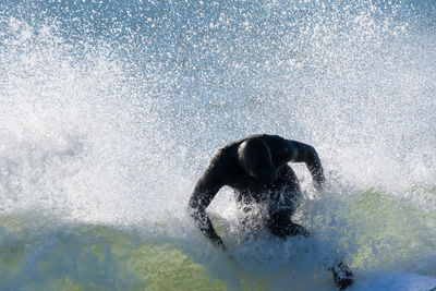 Man splashing water in sea