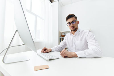 Portrait of businessman using laptop at home