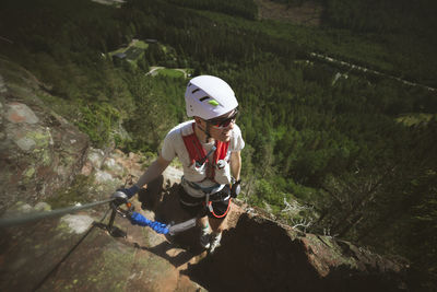 Man mountain climbing with equipment