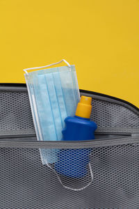 High angle view of bottle on table against yellow background