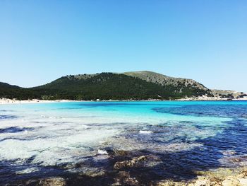 Scenic view of sea against clear blue sky