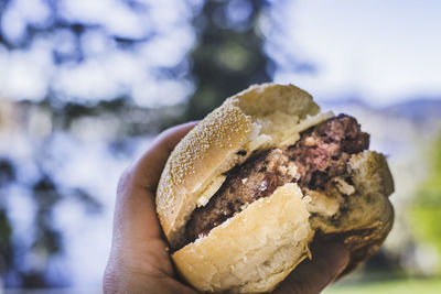 Close-up of hand holding burger