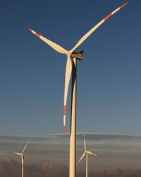 Low angle view of windmill on landscape against sky