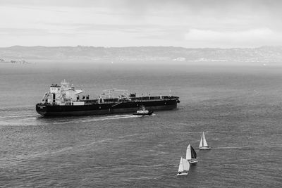 Ship sailing on sea against sky