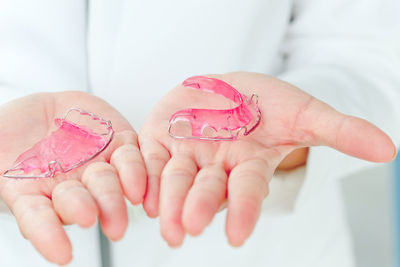 Close-up of dentist holding braces