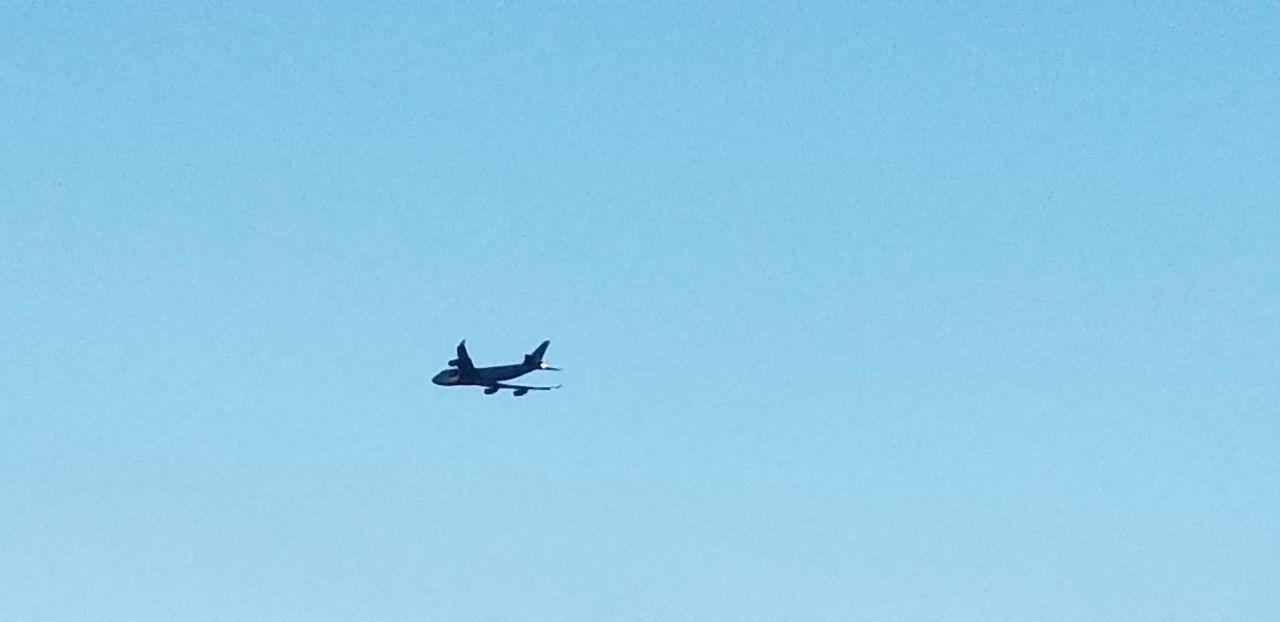 LOW ANGLE VIEW OF AIRPLANE IN FLIGHT