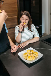 Portrait of boy eating food at home
