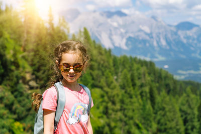 Portrait of smiling woman against mountains