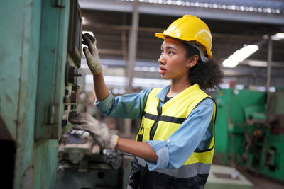 Side view of man working in factory