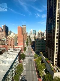 High angle view of street amidst buildings in city against sky