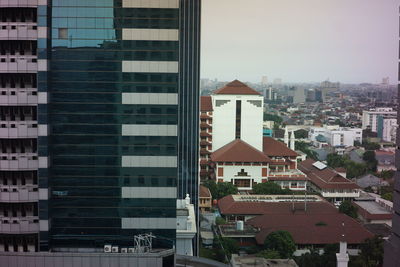 Buildings in city against clear sky