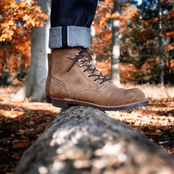 Low section of person standing by autumn leaves